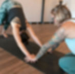 Yoga teacher providing a Downward Facing Dog assist at Yoga Loft Tucson
